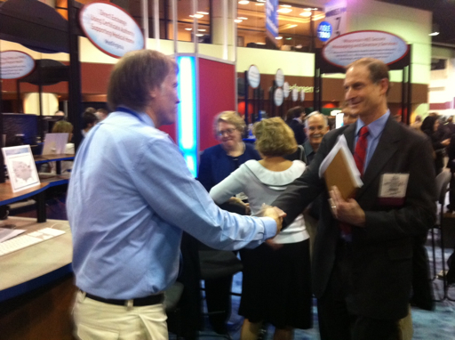 Will Ross and David Blumenthal shake hands and thank each other at HIMSS 2011